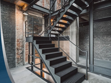 Fabricated steel staircase inside an industrial building